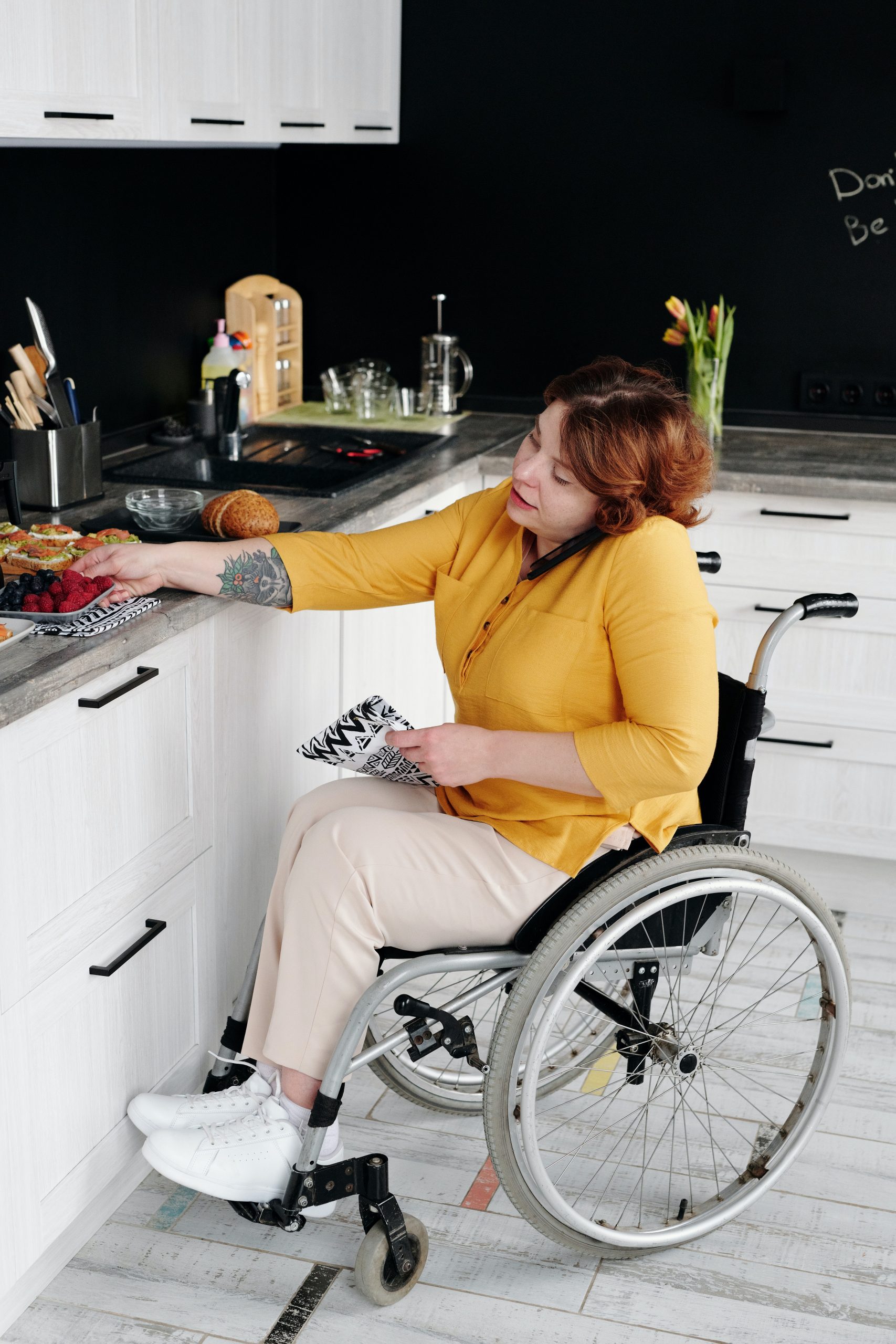 Occupational Therapist Sunshine Coast - woman in wheelchair on mobile phone