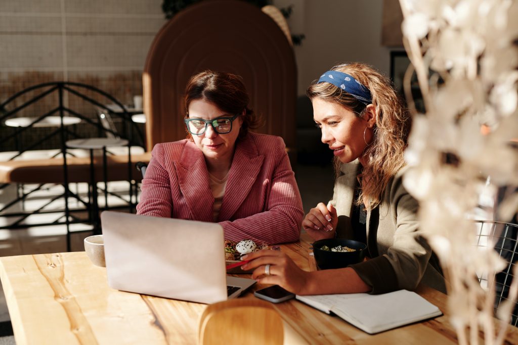 NDIS - two women sitting at table using laptop