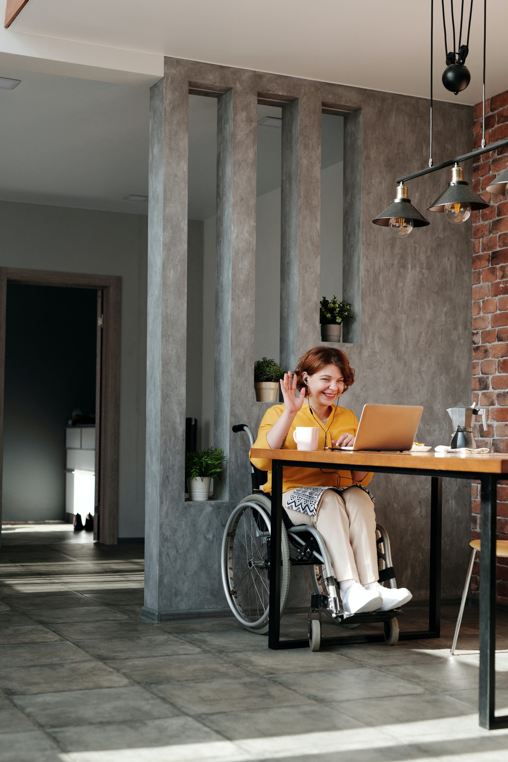 NDIS - woman in wheelchair sitting at table