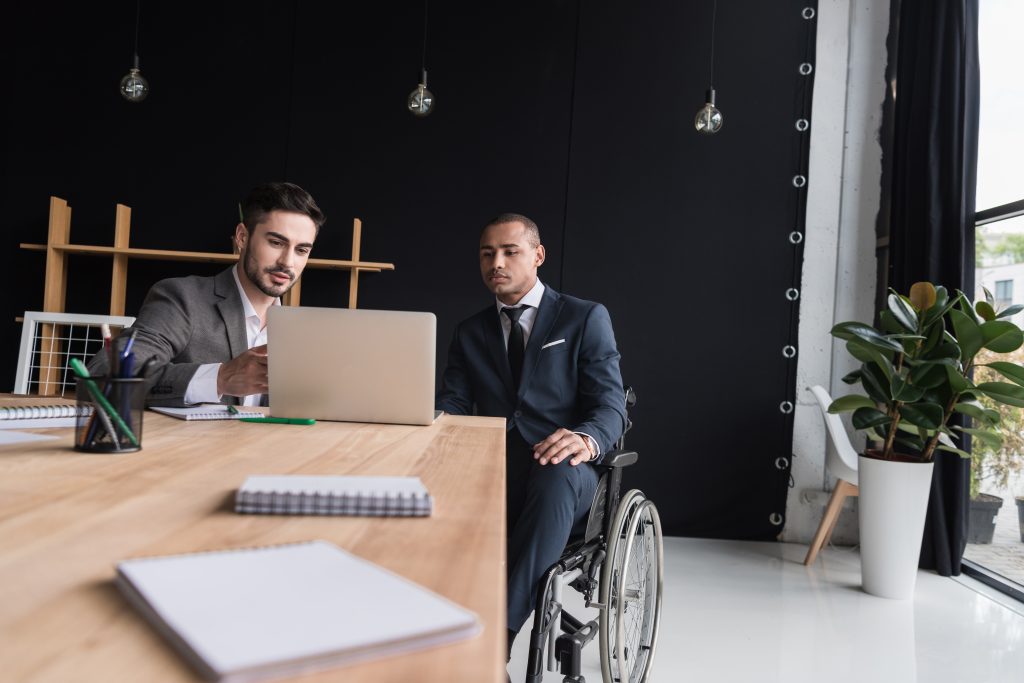 Return to Work - man in wheelchair in a business setting